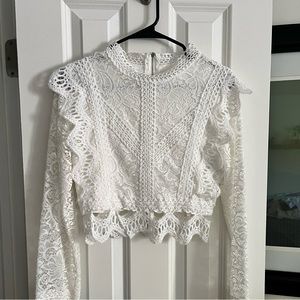 White crochet long sleeved  crop top.  Bodice is lined and sleeves are not